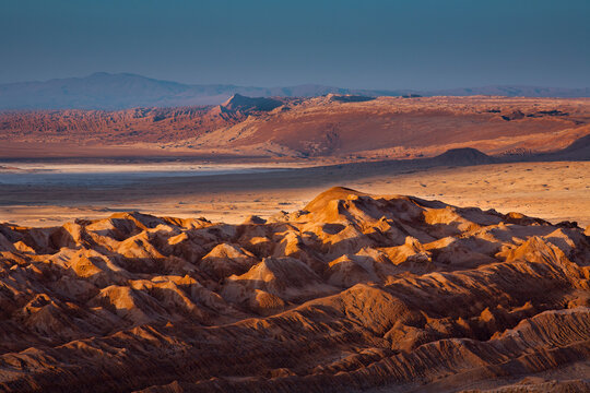 Early morning sunshine lights the rugged Valley of the Moon in the Atacama Desert in northern Chile.