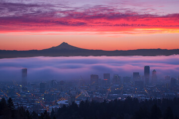 Fog rolling over Portland in sunrise color