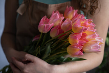 Close-up of a bouquet of tulips in the hands of a woman