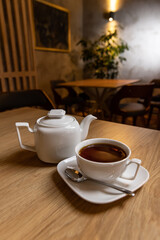 White porcelain tea cup and teapot