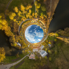 little planet 360-pano - amazing summer countryside landscape - houses, gardens, small park, winding mountain river among the green sunflower field on a sunny summer day. color