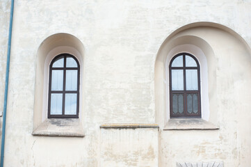Old facades of a gothic building, doors and windows