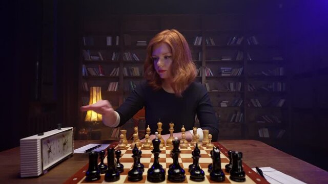 Two chess players man and woman play chess. Debut Accepted Queen's Gambit, King's Gambit, Philidor's Defense. Cinematic filming of a chess game. Antique chess board. This shot can be used for films.