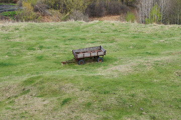 The old soviet abandoned  trailer on a grass.