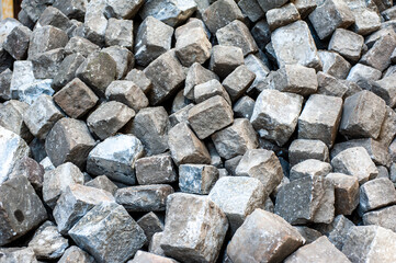 Many old cobblestones from the road are stacked