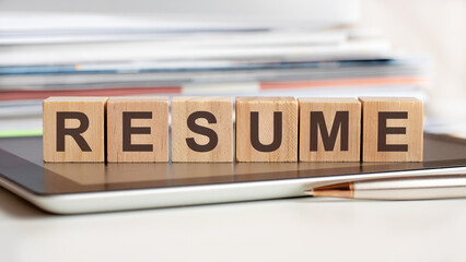 the word resume is written on wooden cubes, concept