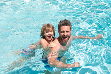 Summer weekend. Father and son in swimming pool. Pool resort.