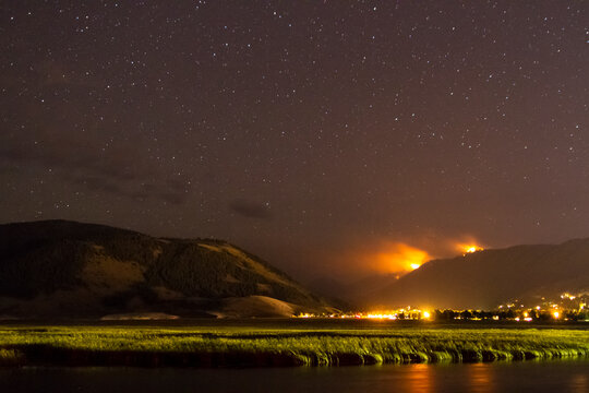 The Little Horsethief Fire burns above Cache Creek and Jackson, Wyoming on a clear night sky.