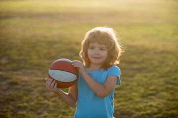 Cute child boy plays basketball. Active kids enjoying outdoor game with basketball ball.