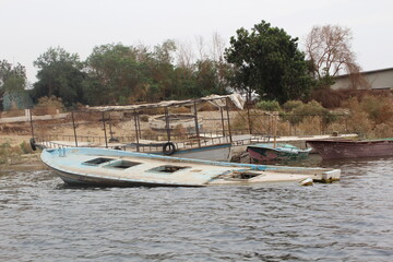Fototapeta na wymiar Small colorful boats on the shore of Naser lake in Aswan in Egypt