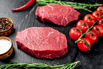 raw beef steak with spices on stone background