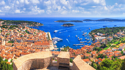 Coastal summer landscape from the fortress - top view of the town of Hvar, on the island of Hvar, the Adriatic coast of Croatia - obrazy, fototapety, plakaty