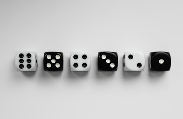 Black and white dice in various positions.