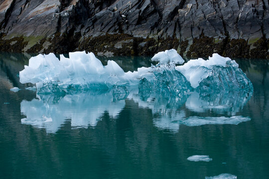 A small iceberg floats in Alaska's Tracy Arm fjord after having recently calved from the Sawyer Glacier.