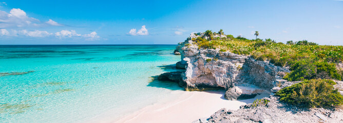 Turquoise blue waters, dramatic limestone cliffs, and powder soft white sand beach at Lighthouse Point on the island of Eleuthera, The Bahamas