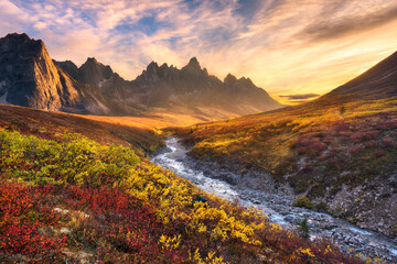 Beautiful sunset light and colorful tundra looking toward Tombstone Mountain during Autumn in the Ogilvie Mountain wilderness, Yukon Territory.