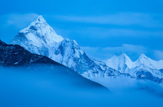 Fog sweeps down the Khumbu Valley in front of Ama Dablam near the village of Lobuche in Nepal.