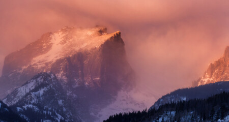 Hallet Peak, in Rocky Mountain National Park, at sunrise as a winter snowstorm is beginning to affect the mountains along the Front Range.