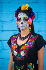 Woman's face with ceremonial make-up also known as Sugar skull, used in traditional Mexican Dia de los Muertos celebration