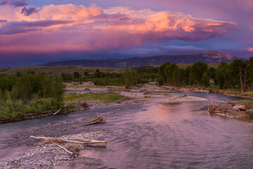 A fiery sunset glows above The Sleeping Indian, aka Sheep Mountain, above the Gros Ventre River in Grand Teton National Park, Wyoming.