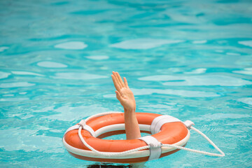 Drowning concept. No swimming. Rescue swimming ring in water. Safety water equipment.