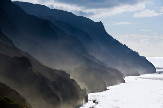 The Fluted Ridges Of The Na Pali Coast Rise Above The Crashing Surf On The North Shore Of Kauai, Hawaii