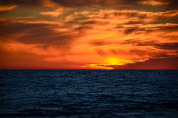 Glowing clouds at sunset over the sea