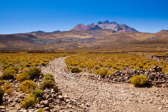 A very rocky and steep road below Mt. Thunupa volcano, next to the Salar de Uyuni in Bolivia's Altiplano.