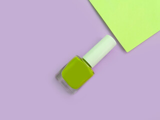 bottle of nail polish on a colored background