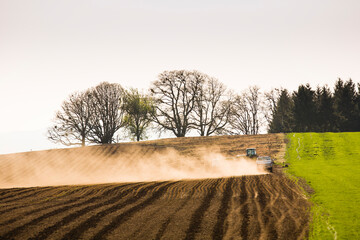 A view of a farmers field, one plowed and another producing vegetables, sit side-by-side, south of Portland, Oregon in the early spring.
