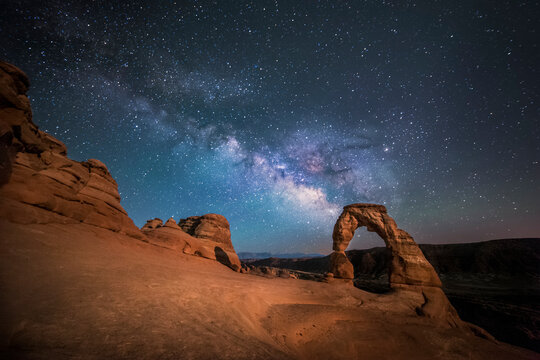 The Milky Way shines over Delicate Arch at Arches National Park (Utah, USA).
