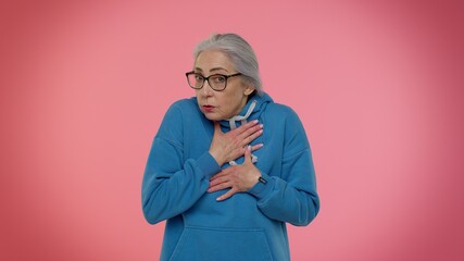 I am not guilty. Confused senior old granny gray-haired woman pointing fingers himself ask say who me no thanks i do not need it isolated on pink studio background. Elderly grandmother pensioner - obrazy, fototapety, plakaty