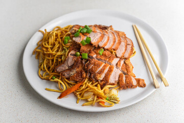 Asian noodles with crispy roast duck and vegetables