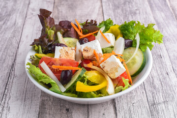 Greek salad on the wooden table