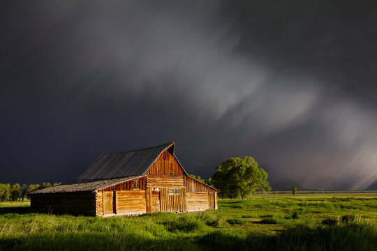 Scenic landscape image of the Moulton Barn with storm clouds, Grand Teton National Park, Wyoming.