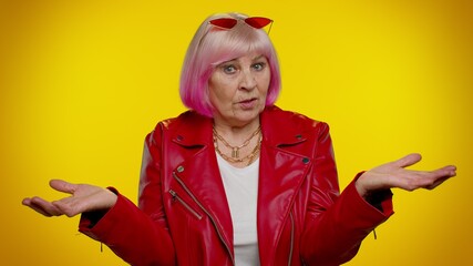 How could you. Elderly rocker granny woman raising hands in indignant expression, asking why what...