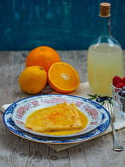 Crêpes served with an orange sauce, fresh raspberry and limoncello liqueur