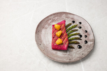 Beetroot marinated salmon with asparagus and pineapple.