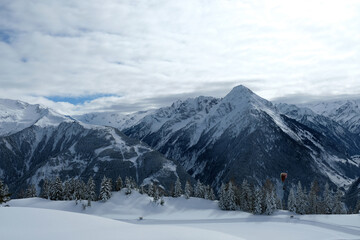 Naklejka premium Landscape at Penken ski resort in Zillertal in Tyrol. Austria in winter in Alps. Alpine mountains with snow. Paragliding around Mayrhofen, Austria