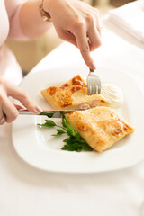 Pancake with sausages in a cut feed on a white background