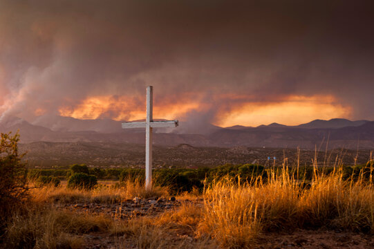 View of forest fires in New Mexico at sunset, fires burning near Los Alamos can be seen in distance.