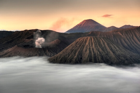 A sea of clouds covers the caldera at sunrise in Bromo-Tengger-Semeru National Park on the island of Java in Indonesia