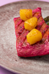 Beetroot marinated salmon with asparagus and pineapple.
