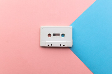 vintage white cassette tape on a blue and pink background
