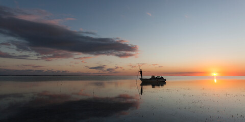 A boater uses a push pole to navigate the mangrove flats of Florida Bay within Everglades National Park, Florida.