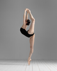Young beautiful skinny ballerina is posing in studio - 432034087