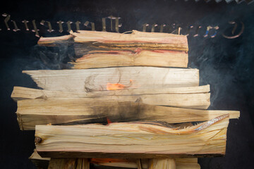 Dry wood in the grill for kindling and making coals