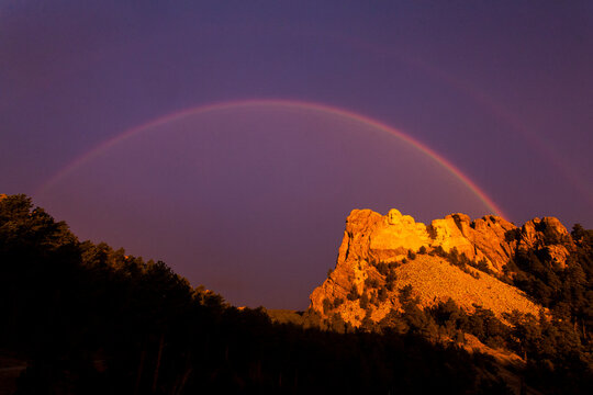 A double rainbow arches over the presidents of Mount Rushmore, South Dakota.