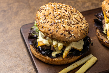 Delicious burgers with asparagus, cheese, tomato and salad