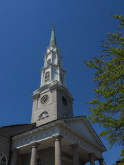 Fototapeta na wymiar Ornate church bell tower against a beautiful blue sky.